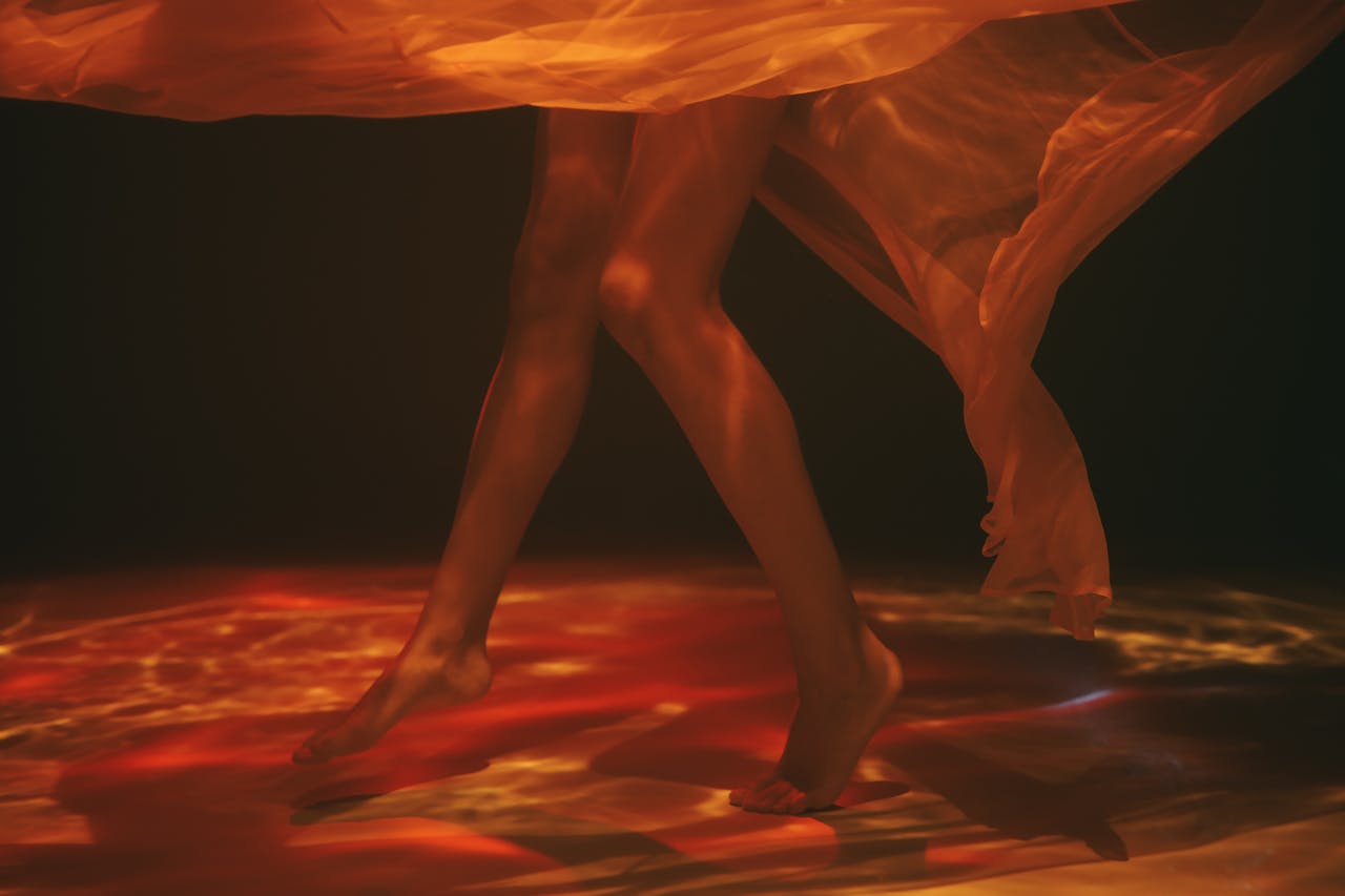 about-01 Creative underwater photo of legs and sheer fabric with a moody, ethereal feel.